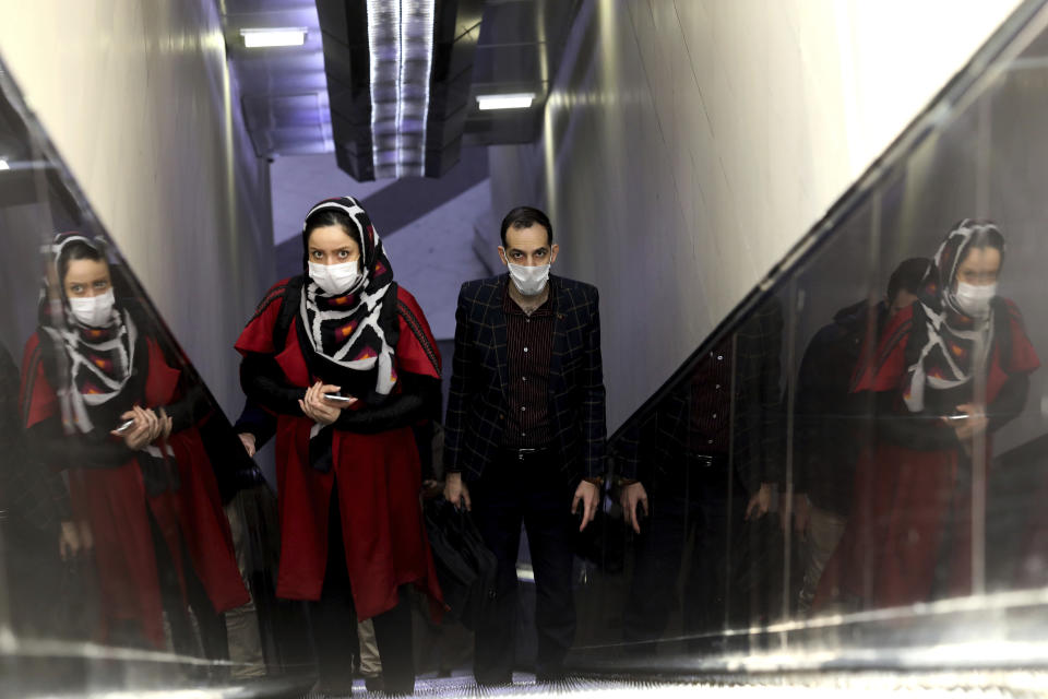 People wear masks to help guard against the Coronavirus as they ride an escalator at a the metro station, in Tehran, Iran, Sunday, Feb. 23, 2020. Iran's health ministry raised Sunday the death toll from the new virus to 8 people in the country, amid concerns that clusters there, as well as in Italy and South Korea, could signal a serious new stage in its global spread. (AP Photo/Ebrahim Noroozi)