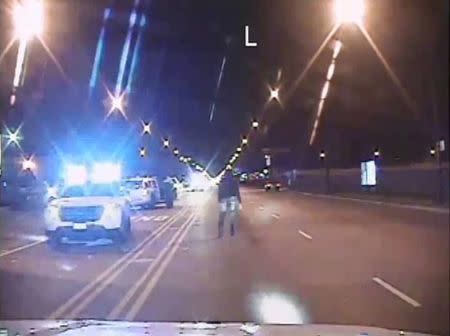 Laquan McDonald (R) walks on a road before he was shot 16 times by police officer Jason Van Dyke in Chicago, in this still image taken from a police vehicle dash camera video shot on October 20, 2014, and released by Chicago Police on November 24, 2015. REUTERS/Chicago Police Department/Handout via Reuters/Files