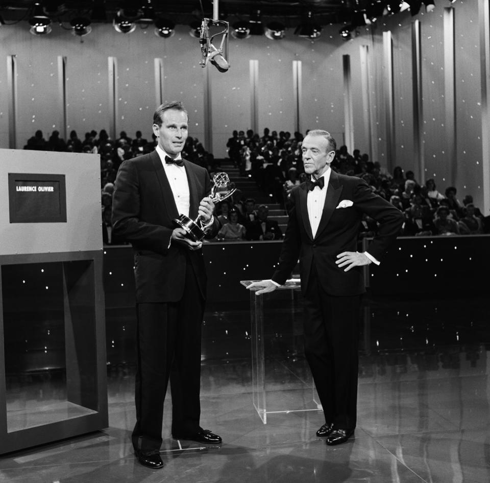 <p>Fred Astaire looks on as Charlton Heston (<em>Touch of Evil</em>,<em> Ben-Hur</em>,<em> Planet of the Apes</em>) presents the award for Outstanding Lead Actor - Miniseries or a Movie.</p>