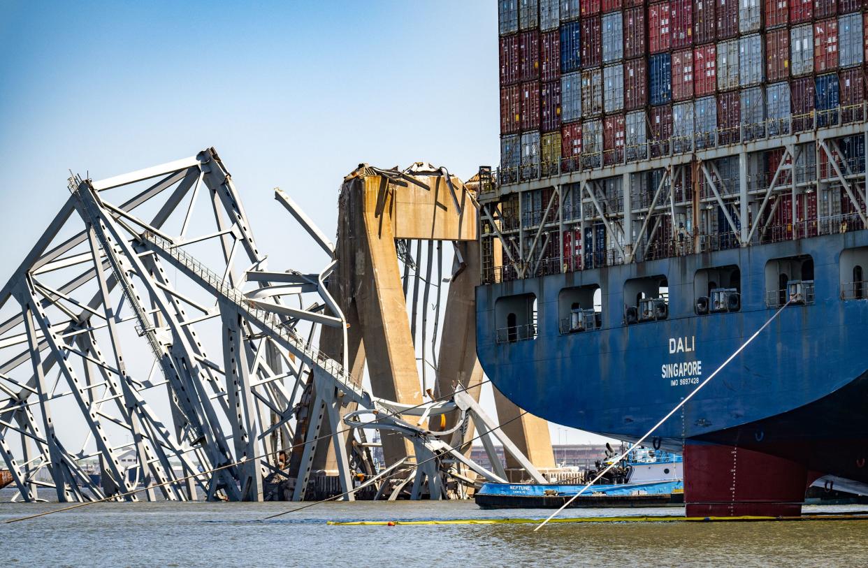 The wreckage of the Francis Scott Key Bridge is seen beyond the stern of the container ship Dali weeks after the catastrophic collapse.