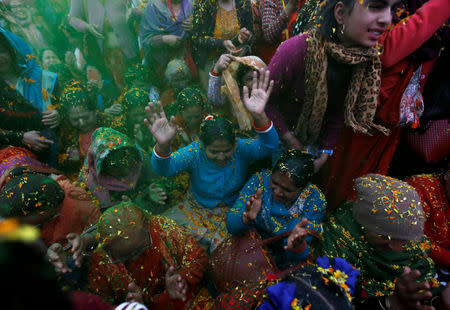 Devotees sing and dance as flower petals and colour are thrown while celebrating puspa holi to mark the Gaura Purnima festival in Kathmandu, Nepal March 21, 2019. The festival is celebrated to mark the day when Lord Krishna changed his colour to golden and advent as Gauranga. REUTERS/Navesh Chitrakar