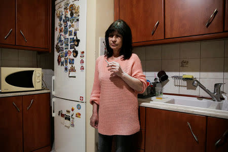 Eleni Skopelitis smokes in her kitchen in the suburb of Nikaia, in Athens, Greece, March 24, 2017. REUTERS/Alkis Konstantinidis