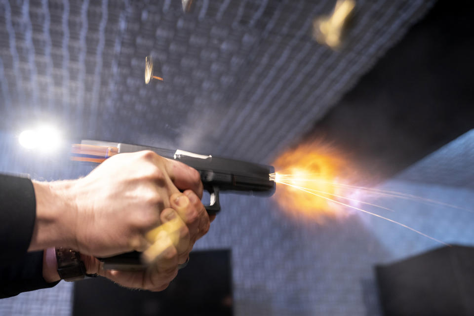 A semi-automatic pistol with a conversion device installed making it fully automatic is fired as four empty shell casings fly out of the weapon, at the Bureau of Alcohol, Tobacco, Firearms, and Explosives (ATF), National Services Center, Thursday, March 2, 2023, in Martinsburg, W.Va. Machine guns have been illegal in the U.S. for decades, but in recent years the country has seen a new surge of weapons capable of automatic fire. Small pieces of plastic or metal used to convert legal guns into homemade machine guns are helping to fuel gun violence. (AP Photo/Alex Brandon)