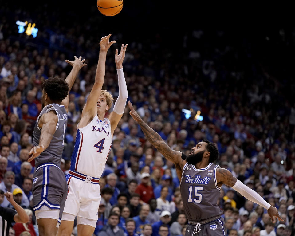 Kansas guard Gradey Dick (4) shoots over Seton Hall forward Tray Jackson (1) during the first half of an NCAA college basketball game Thursday, Dec. 1, 2022, in Lawrence, Kan. (AP Photo/Charlie Riedel)