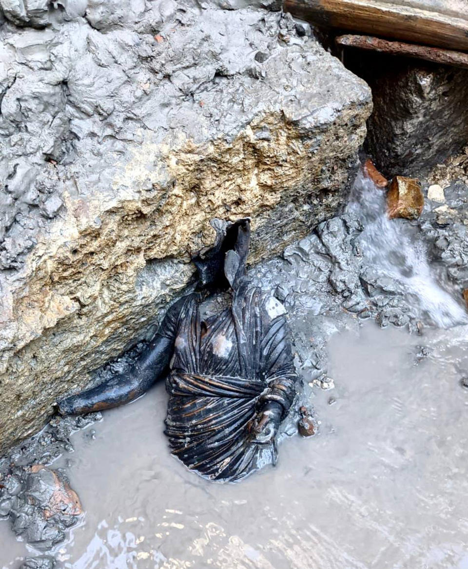A statue is seen at the site of the discovery of two dozen well-preserved bronze statues from an ancient Tuscan thermal spring in San Casciano dei Bagni, central Italy, in this undated photo made available by the Italian Culture Ministry, Thursday, Nov. 3, 2022. (Italian Culture Ministry via AP)
