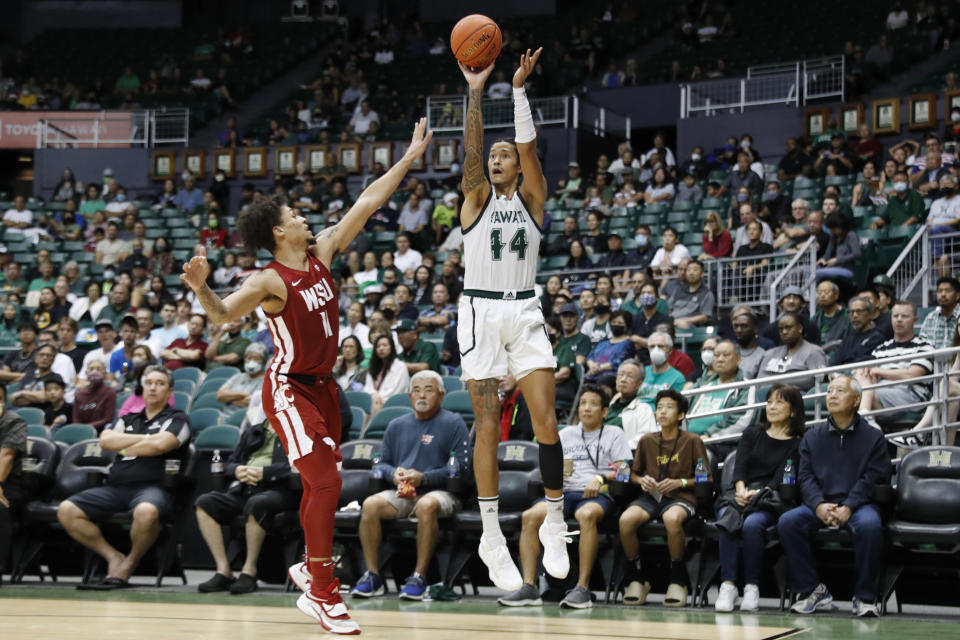 Hawaii forward Kamaka Hepa (44) attempts a shot over Washington State forward DJ Rodman (11) during the second half of an NCAA college basketball game, Friday, Dec. 23, 2022, in Honolulu. (AP Photo/Marco Garcia)