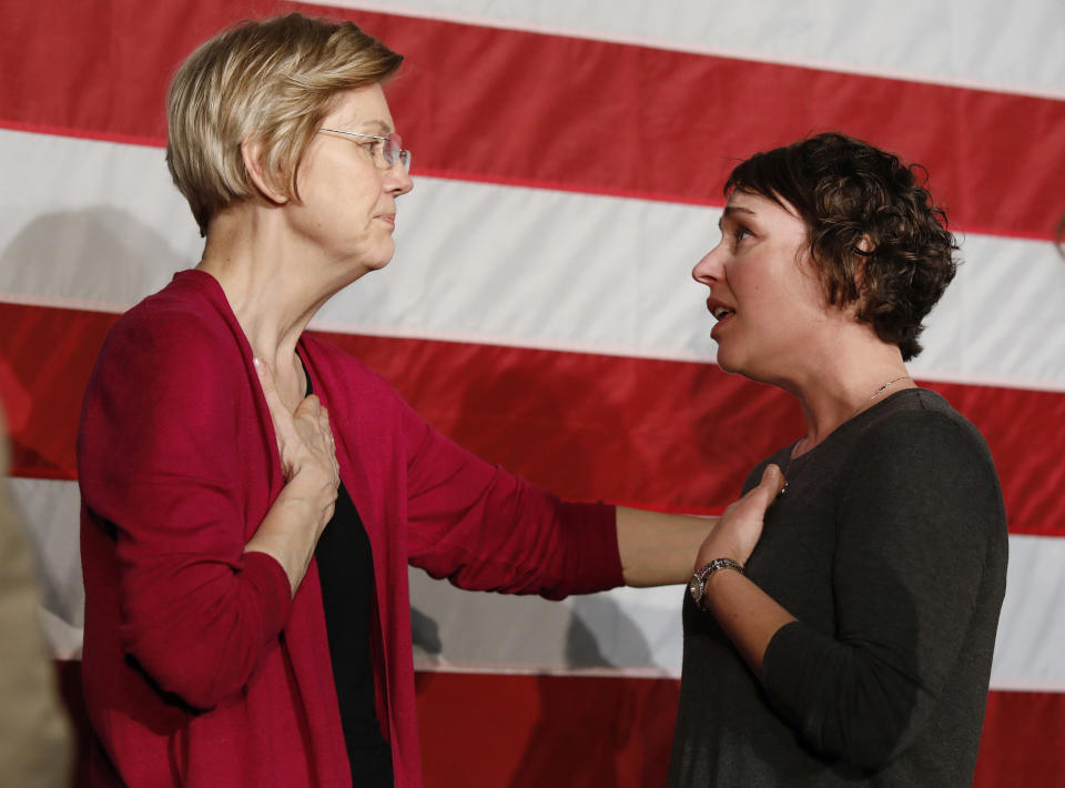 Sen. Elizabeth Warren, D-Mass., left, talks with Christa Lautner, right, of Urbandale about student loans and predatory lending after an organizing event at Curate event space in Des Moines, Iowa, on Saturday, Jan. 5, 2019. (AP Photo/Matthew Putney)