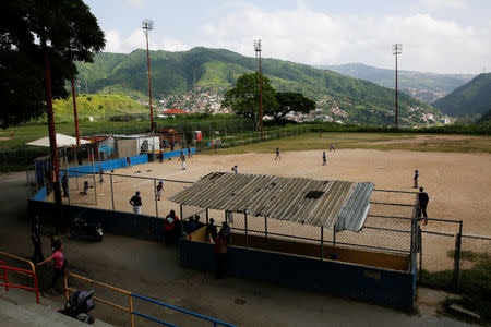 Children play baseball during a championship in Caracas, Venezuela August 24, 2017. REUTERS/Carlos Garcia Rawlins/Files