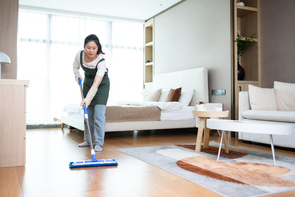 asian woman cleaning floor house with mop