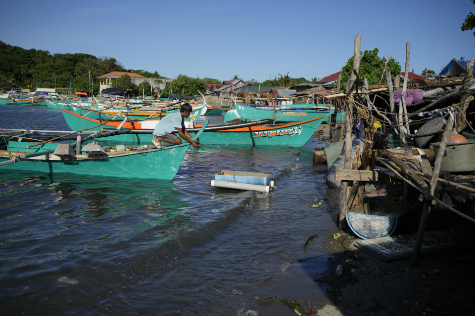 A man prepares his boat at the port of the coastal town of Santa Ana, Cagayan province, northern Philippines on Tuesday, May 7, 2024. The United States and the Philippines, which are longtime treaty allies, have identified the far-flung coastal town of Santa Ana in the northeastern tip of the Philippine mainland as one of nine mostly rural areas where rotating batches of American forces could encamp indefinitely and store their weapons and equipment within local military bases under the Enhanced Defense Cooperation Agreement, or EDCA. (AP Photo/Aaron Favila)