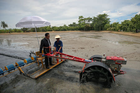 Thailand's Prime Minister Prayuth Chan-ocha rides on a tractor at a farmer school in Suphan Buri province, Thailand September 18, 2017. REUTERS/Athit Perawongmetha