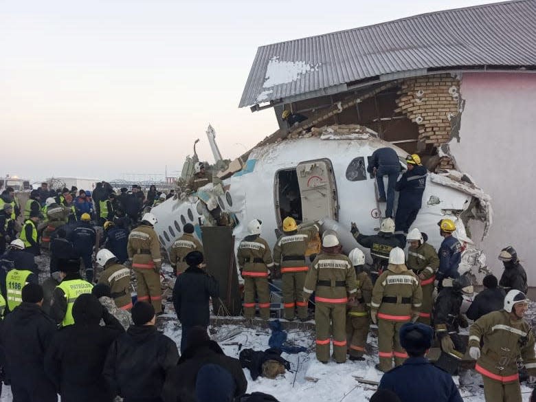 Emergency and security personnel are seen at the site of the plane crash near Almaty, Kazakhstan, December 27, 2019.