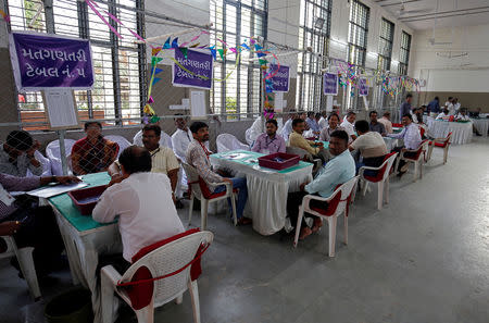 Election staff members wait for counting to start inside a vote counting centre in Ahmedabad, India, May 23, 2019. REUTERS/Amit Dave