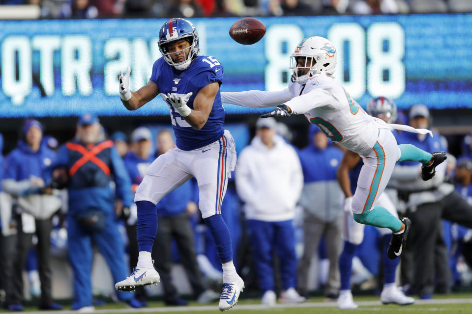 New York Giants wide receiver Golden Tate (15) makes a catch on his way to score a touchdown in front of Miami Dolphins defensive back Nik Needham (40) during the first half of an NFL football game, Sunday, Dec. 15, 2019, in East Rutherford, N.J. (AP Photo/Adam Hunger)