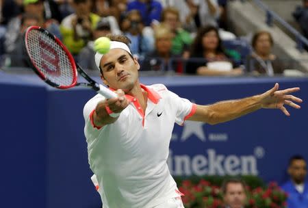 Roger Federer of Switzerland chases down a forehand to Novak Djokovic of Serbia during their men's singles final match at the U.S. Open Championships tennis tournament in New York, September 13, 2015. REUTERS/Mike Segar