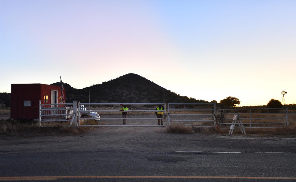 Security guards stand behind a locked gate at the entrance to the Bonanza Creek Ranch on October 22, 2021 in Santa Fe, New Mexico.
