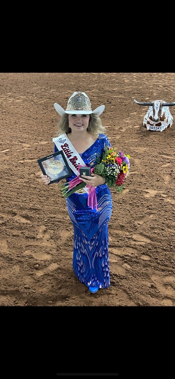 Mary Ivey poses for the cameras after she was crowned Queen at the National Little Britches Association finals at the Lazy E Arena in Guthrie, Oklahoma.