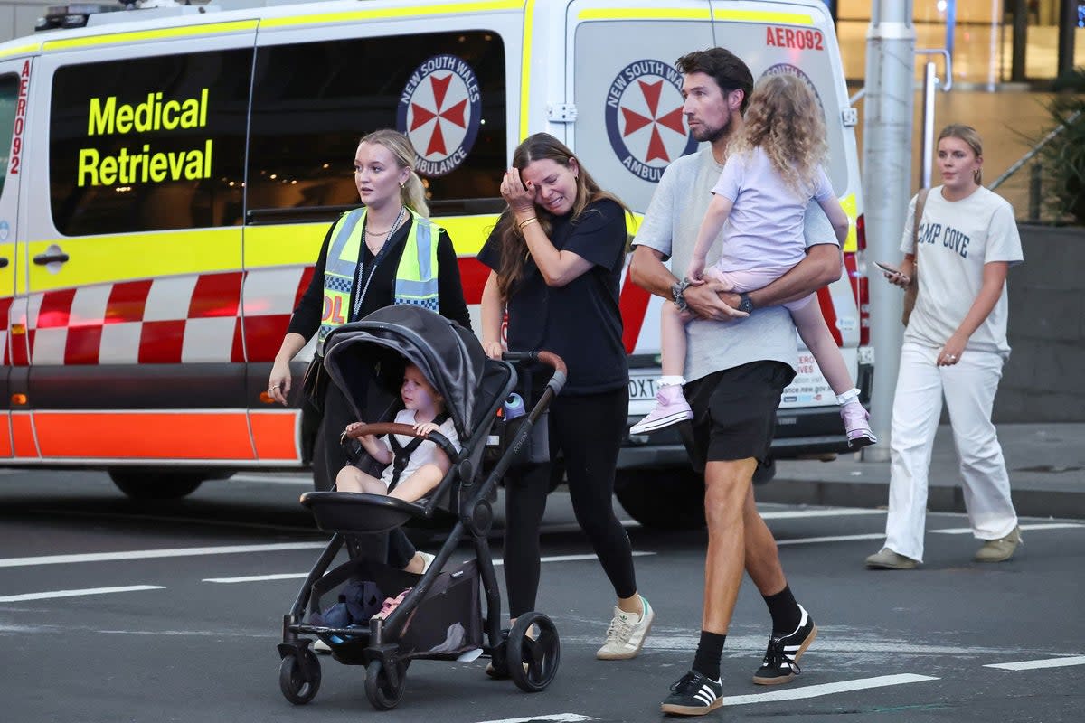 A woman cries as she comes out of the Westfield Bondi Junction shopping mall (AFP via Getty Images)