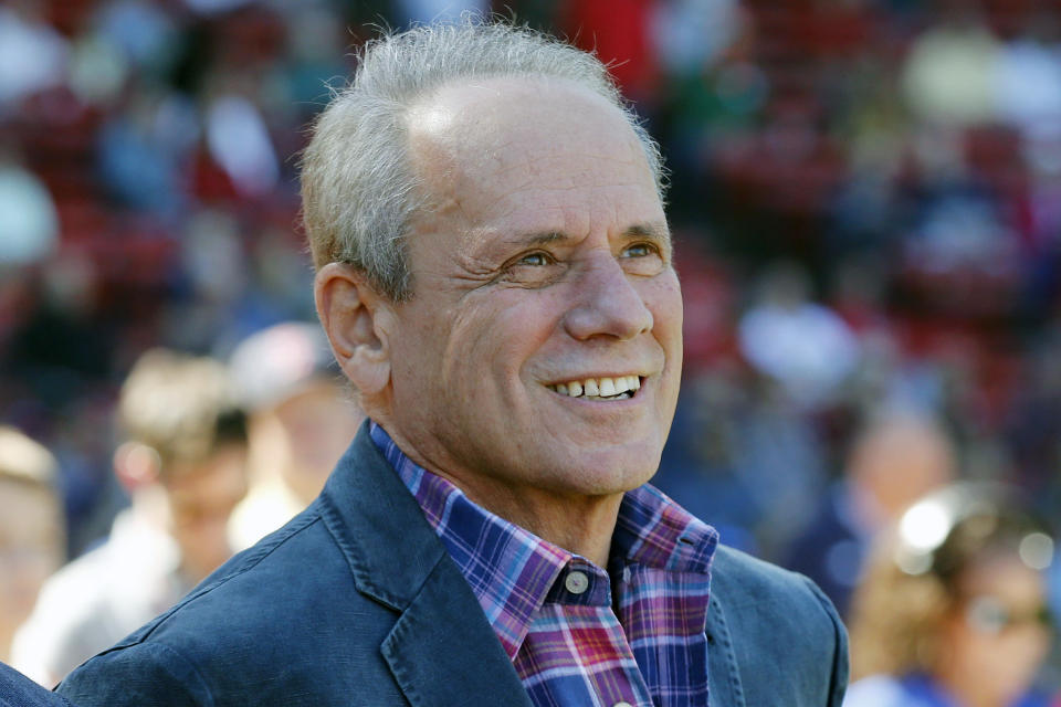 FILE - Boston Red Sox president and CEO Larry Lucchino watches a video tribute before a baseball game between the Red Sox and the Baltimore Orioles in Boston, Sunday, Sept. 27, 2015. Larry Lucchino, the force behind baseball’s retro ballpark revolution and the transformation of the Boston Red Sox from cursed losers to World Series champions, has died. He was 78. Lucchino had suffered from cancer. The Triple-A Worcester Red Sox, his last project in a career that also included three major league baseball franchises and one in the NFL, confirmed his death on Tuesday, April 2, 2024.(AP Photo/Michael Dwyer, File)