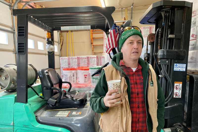 Jerry Pritchard drinks coffee in the warehouse of his construction management company in Northampton