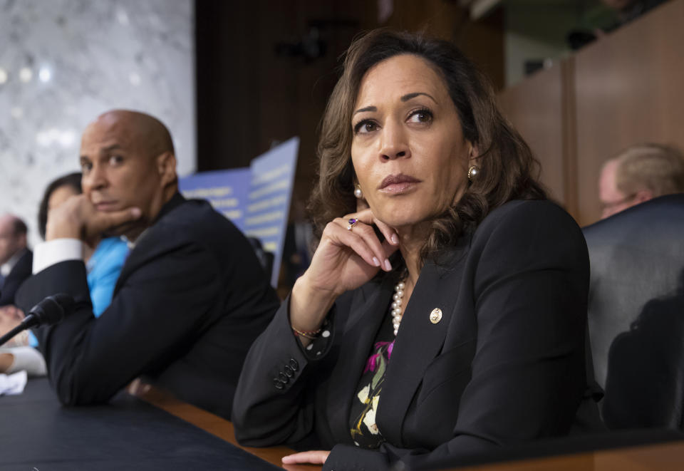 Sen. Kamala Harris, D-Calif., and Sen. Cory Booker, D-N.J., left, pause as protesters disrupt the confirmation hearing of President Donald Trump's Supreme Court nominee, Brett Kavanaugh, on Capitol Hill in Washington, Tuesday, Sept. 4, 2018. (AP Photo/J. Scott Applewhite)