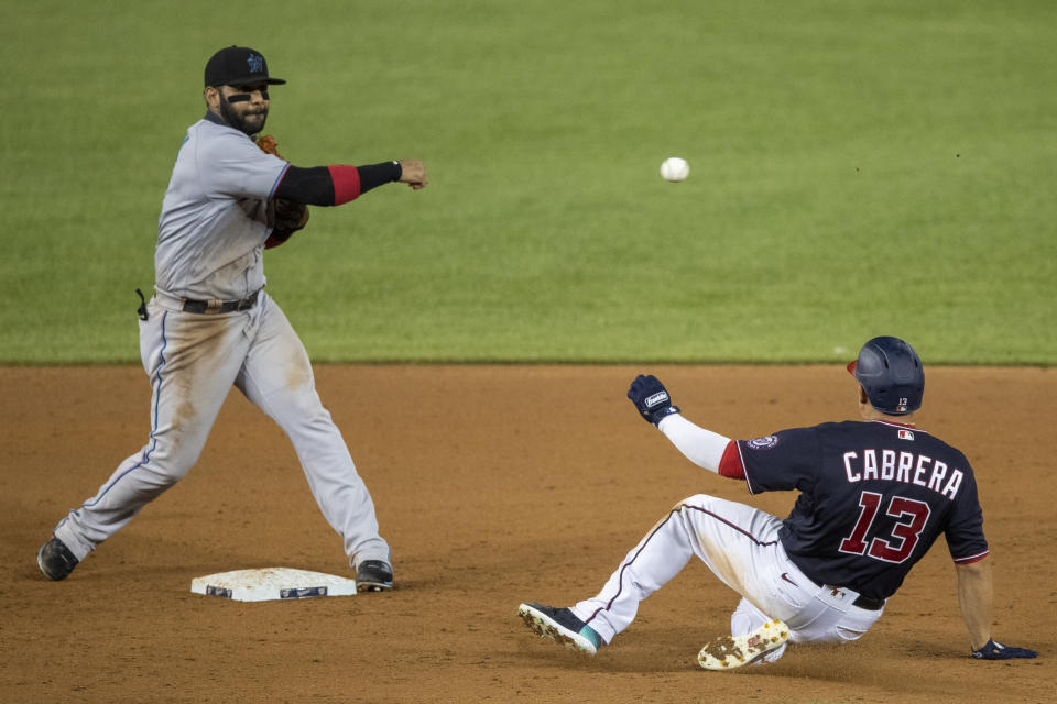 Washington Nationals' Asdrubal Cabrera (13) is out at second as Miami Marlins second baseman Jonathan Villar, throws to first during the ninth inning of a baseball game in Washington, Monday, Aug. 24, 2020. (AP Photo/Manuel Balce Ceneta)