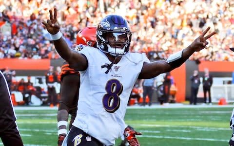 Baltimore Ravens quarterback Lamar Jackson celebrates a 12-yard touchdown pass to running back Mark Ingram during the second half of an NFL football game against the Cleveland Browns - Credit: AP