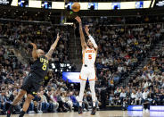 Atlanta Hawks guard Dejounte Murray (5) shoots over Utah Jazz forward Brice Sensabaugh (8) during the first half of an NBA basketball game, Friday, March 15, 2024, in Salt Lake City. (AP Photo/Spenser Heaps)