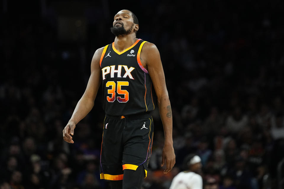 Phoenix Suns forward Kevin Durant (35) reacts to a missed shot during the second half of an NBA basketball game against the Denver Nuggets, Friday, Dec. 1, 2023, in Phoenix. (AP Photo/Matt York)