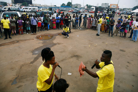 People perform during an awareness caravan against illegal and false drugs in a street of Abobo in Abidjan, Ivory Coast October 11, 2018. Picture taken October 11, 2018. REUTERS/Luc Gnago