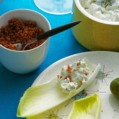 <div class="caption-credit"> Photo by: Iain Bagwell</div><div class="caption-title">Endive "Chips" with Blue Cheese Dip and Bacon Dust</div><b>Endive "Chips" with Blue Cheese Dip and Bacon Dust</b> <br> The iceberg wedge salad gets reinvented. Endives are the perfect vehicle for a condiment as delicious as this one. <br> <b>Recipe</b>: <br> Ingredients <br> <ul> <li>2 strips of thick bacon (2 oz.), chopped </li> <li>1/4 cup Greek-style yogurt </li> <li>1/4 cup crumbled gorgonzola cheese </li> <li>1 teaspoon chopped fresh rosemary, divided </li> <li>1/4 teaspoon black pepper </li> <li>20 leaves of endive (from about 3 heads) </li> </ul>Preparation <br> 1. Cook bacon in a frying pan (not nonstick) over high heat until crisp, about 4 minutes. Drain on a paper towel. Pulse in a food processor to make fine crumbs and put in a serving bowl. <br> 2. Mix together yogurt, cheese, 1/2 tsp. rosemary, and pepper in another serving bowl. Sprinkle with remaining 1/2 tsp. rosemary. Pile endive leaves in a wide bowl and serve with dip and bacon dust.