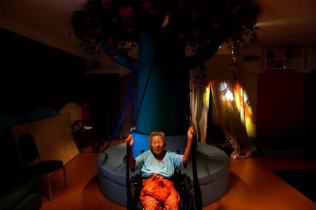 An elderly woman exercises during a physical therapy session at Bangkhae Home Foundation in Bangkok, Thailand, April 27, 2016. REUTERS/Athit Perawongmetha