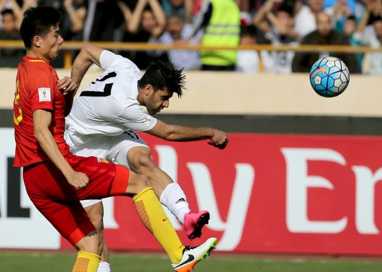 Iran's Mehdi Taremi (right) in action against China during a 2018 World Cup qualifier in Tehran on March 28, 2017