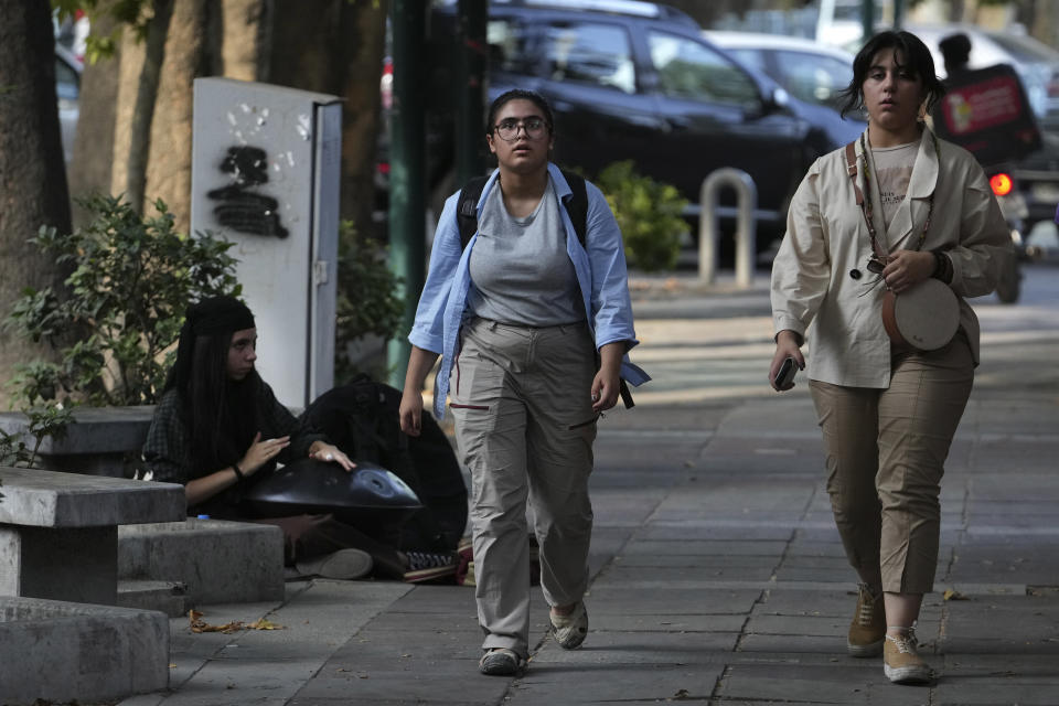 Iranian women walk in Tehran, Iran, Saturday, Aug. 5, 2023. These days, with uncovered women a common sight on Tehran streets, authorities have begun raiding companies where women employees or customers have been seen without the headscarf, or hijab. Iran's parliament is discussing a law that would increase punishments on uncovered women and the businesses they frequent. (AP Photo/Vahid Salemi)