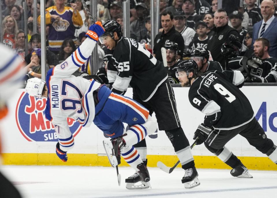 The Kings' Quinton Byfield (55) checks Oilers star Connor McDavid (97) during Game 4 on April 23, 2023.