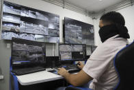 A General Directorate of Prisons employee works in the video surveillance room during a media tour of The Terrorism Confinement Center in Tecoluca, El Salvador, Thursday, Feb. 2, 2023. The "mega-prison" still under construction has a maximum capacity of 40,000 and is intended to imprison gang members, according to the government. (AP Photo/Salvador Melendez)