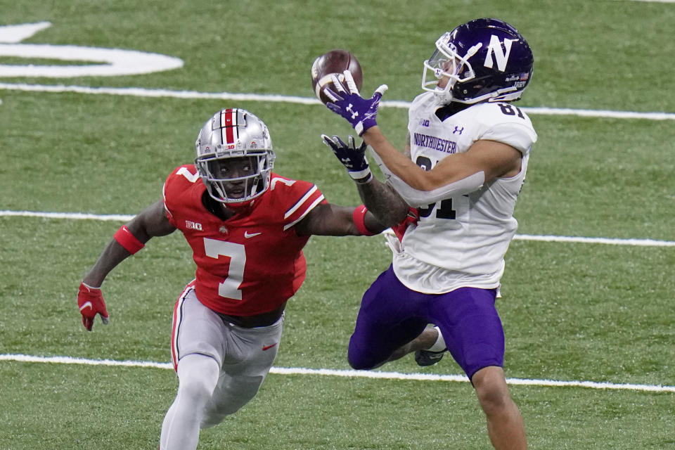 Northwestern wide receiver Ramaud Chiaokhiao-Bowman (81) catches a pass as Ohio State cornerback Sevyn Banks (7) defends during the second half of the Big Ten championship NCAA college football game, Saturday, Dec. 19, 2020, in Indianapolis. (AP Photo/AJ Mast)