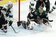 Arizona Coyotes goaltender Antti Raanta (32) dives to make a save on a shot by San Jose Sharks center Logan Couture (39) during the first period of an NHL hockey game Saturday, Jan. 16, 2021, in Glendale, Ariz. (AP Photo/Ross D. Franklin)