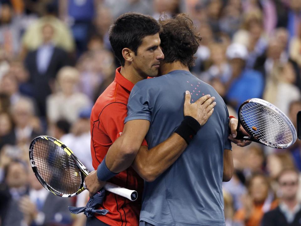 Rafael Nadal of Spain is congratulated by Novak Djokovic of Serbia (L) after his victory in their men's final match at the U.S. Open tennis championships in New York, September 9, 2013.