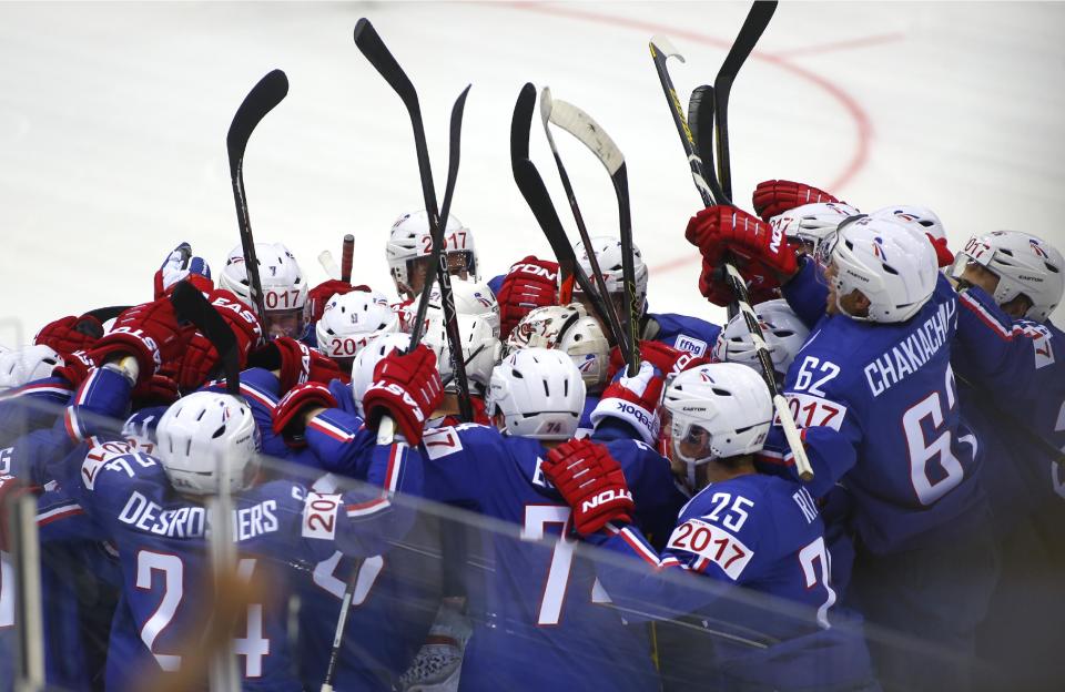 France's players celebrate their victory during Group A preliminary round match against Canada at the Ice Hockey World Championship in Minsk, Belarus, Friday, May 9, 2014. (AP Photo/Sergei Grits)