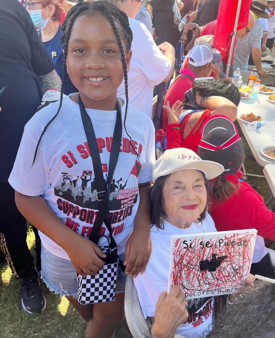 Natalia meets Dolores Huerta, one of her inspirations, at the United Farm Workers march in Stockton on August 20, 2022, and gifts her a painting made by her.