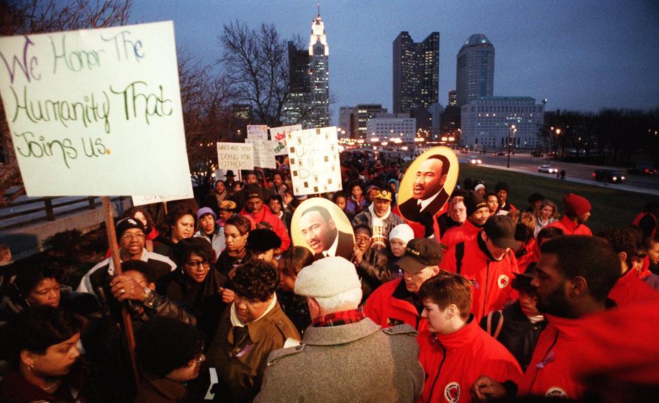 Marchers in the Martin Luther King Day memorial observance in 1995 approach Veterans Memorial after crossing the Broad Street bridge. Dick Rowling, a representative of the National Office of World Federalists, passed out literature supporting the convictions of King.