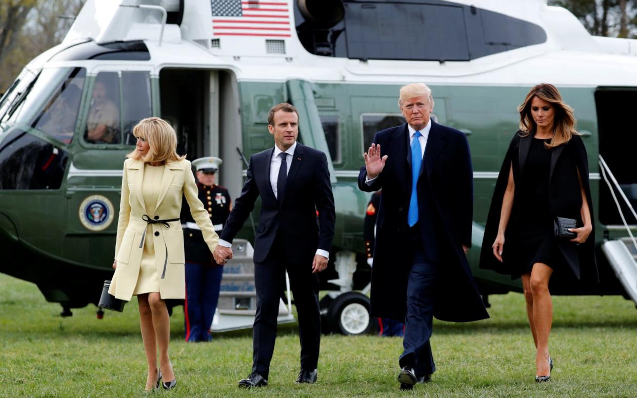 Donald Trump and first lady Melania Trump escort Emmanuel Macron and Brigitte Macron as they arrive together on the Marine One helicopter on a visit to the estate of the first U.S. President George Washington in Mount Vernon - REUTERS