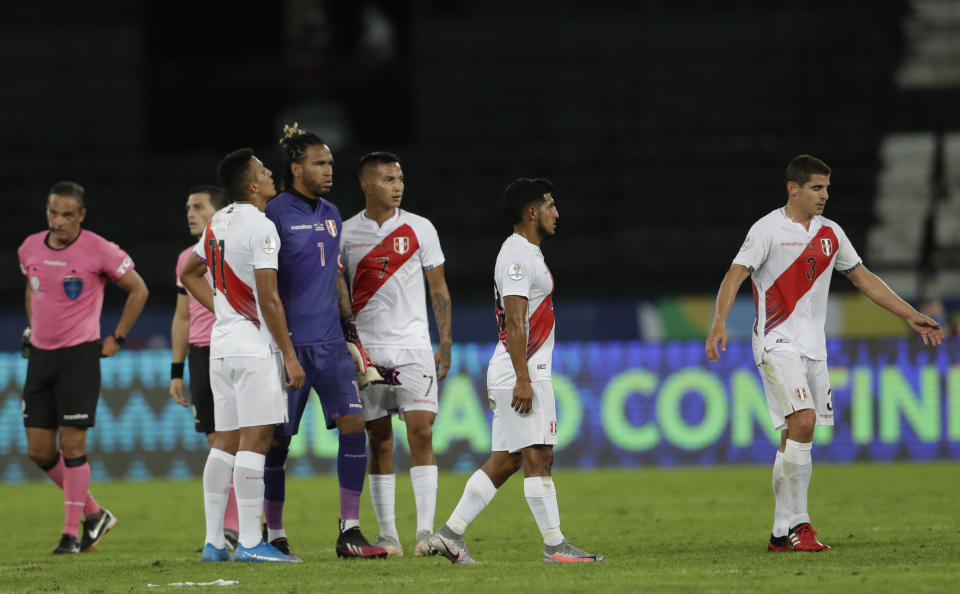 Players or Peru reacts after losing 4-0 against Brazil during a Copa America soccer match at Nilton Santos stadium in Rio de Janeiro, Brazil, Thursday, June 17, 2021 (AP Photo/Silvia Izquierdo)