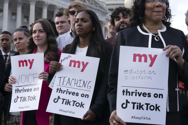 Supporters of TikTok hold signs that read: My voice thrives on TikTok; My teaching thrives on TikTok; My education platform thrives on TikTok.