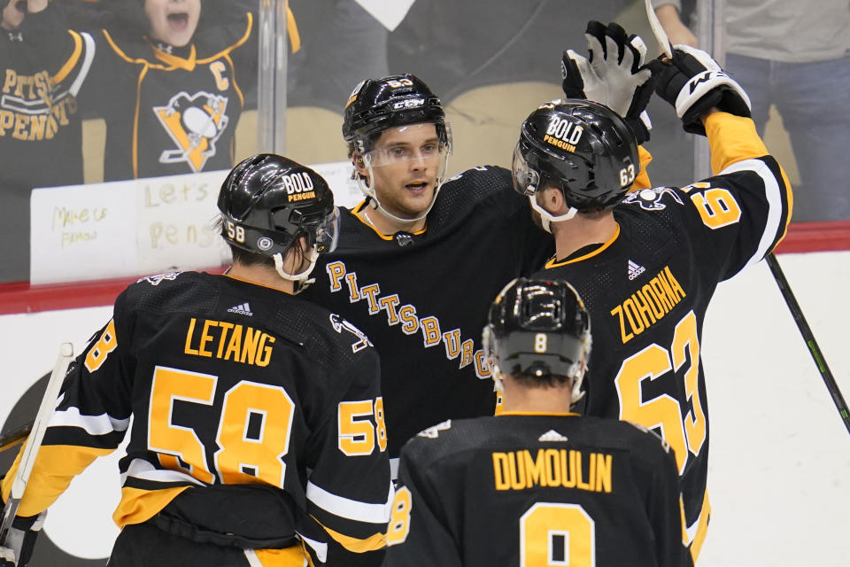 Pittsburgh Penguins' Teddy Blueger (53) celebrates his goal during the first period of an NHL hockey game against the Detroit Red Wings in Pittsburgh, Sunday, March 27, 2022. (AP Photo/Gene J. Puskar)