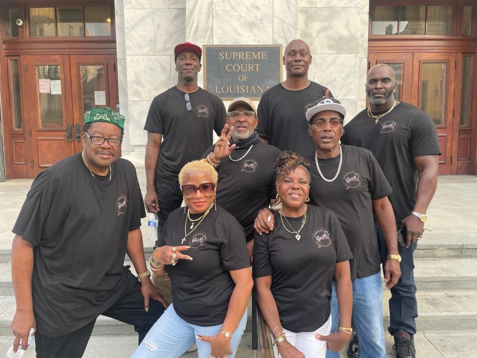 Brandon Jackson stands out front the Louisiana Supreme Court building with a group joined in prayer.