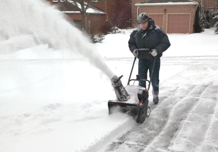 man working with a snow blowing ...