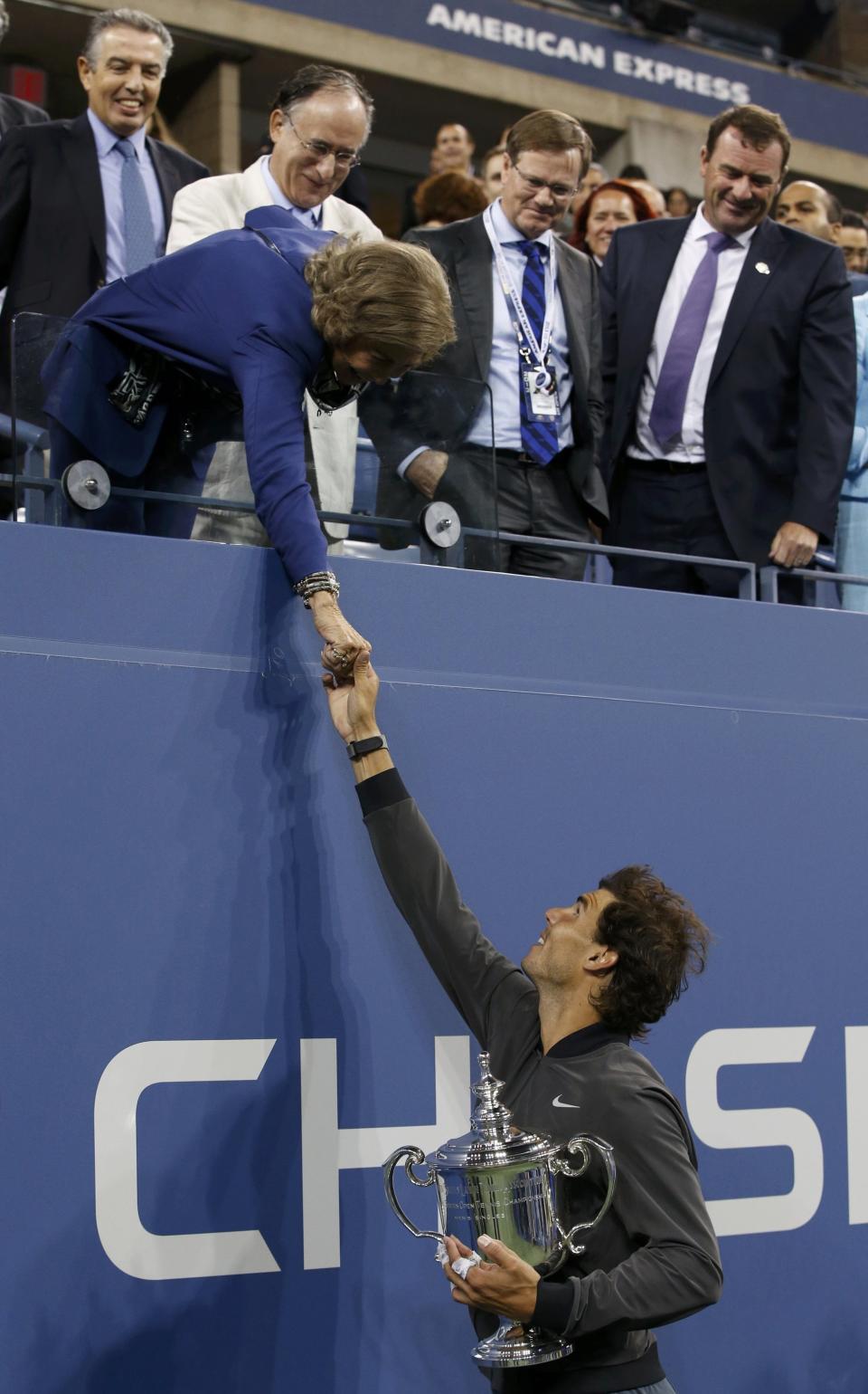 Nadal of Spain holds his trophy as he shakes hands with Queen Sofia of Spain after defeating Djokovic of Serbia in their men's final match at the U.S. Open tennis championships in New York