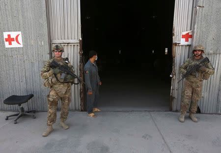 U.S. troops stand guard in front of a police medical warehouse in Kabul, August 27, 2014. REUTERS/Omar Sobhani